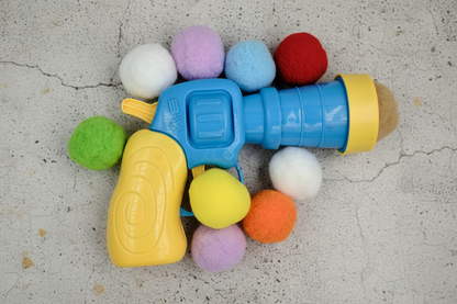 A colourful toy plush gun blaster for cats 