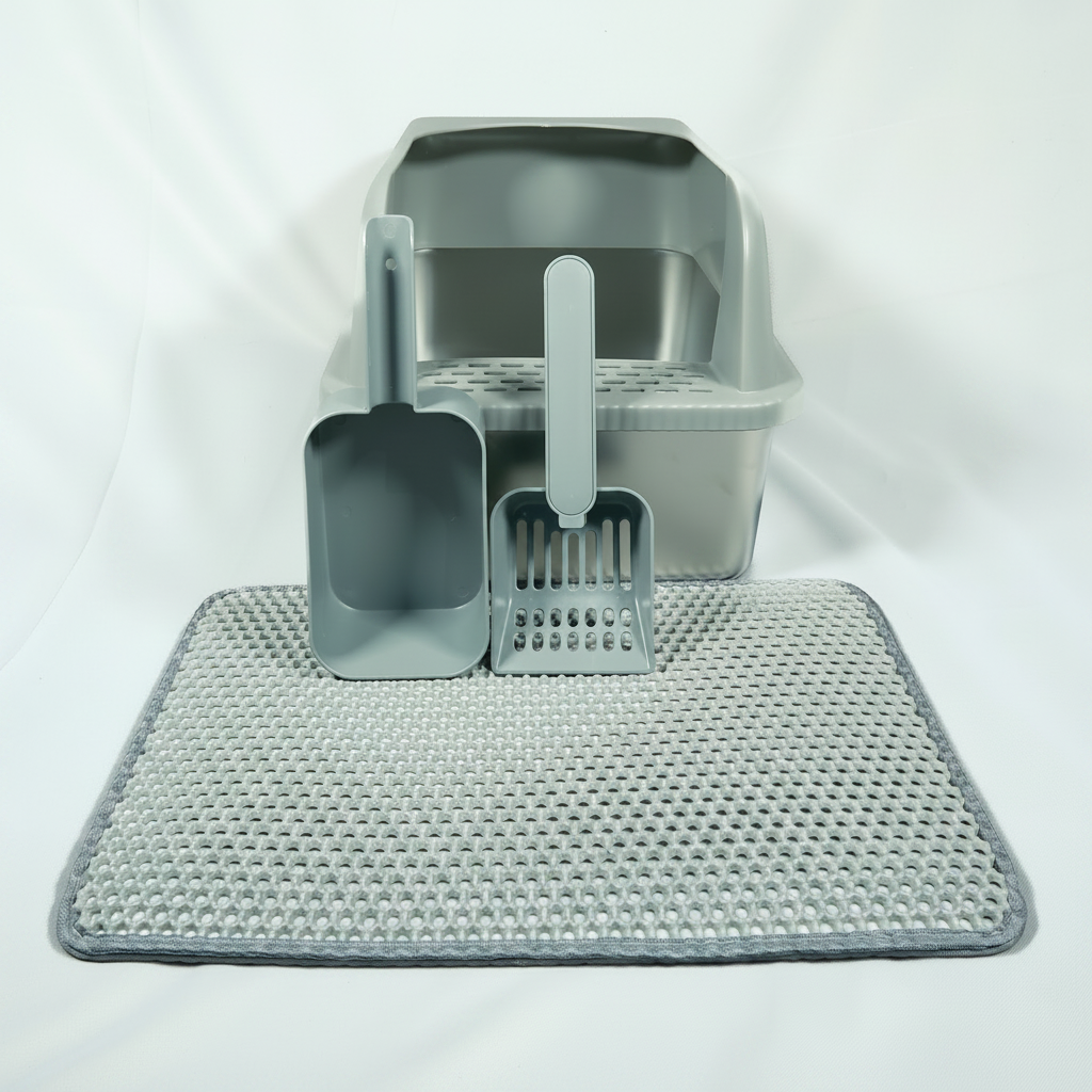 Cat litter cleaning set with a scoop, litter box, and mat on a white background