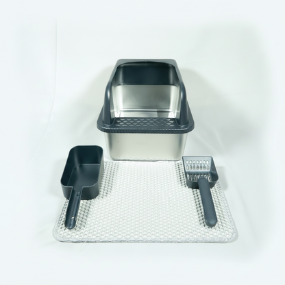 Cat litter box set with scoop, brush, and mat on a white background