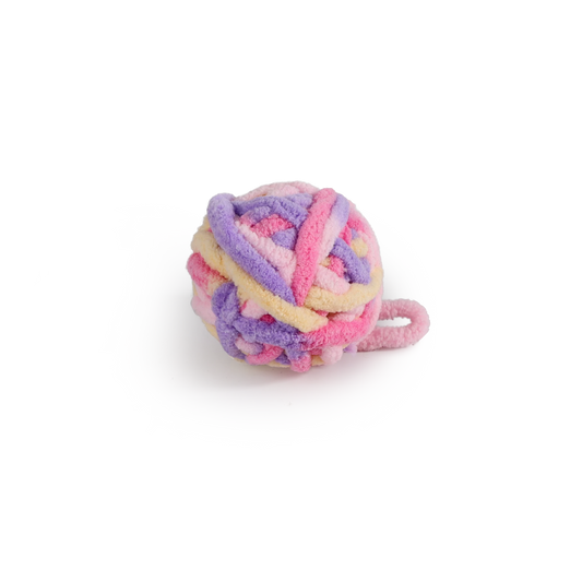 Pastel yarn ball cat toy with striped knotted texture and dangling yarn tail