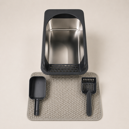Stainless steel and black plastic Cat litter box set with scoop and mat on a beige background