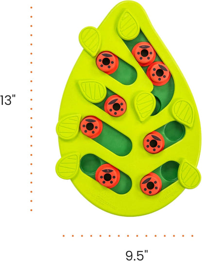 Leaf-shaped green puzzle treat feeder with red ladybug pegs and green sliding cups