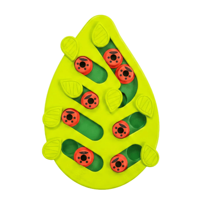 Leaf-shaped green cat puzzle treat feeder with red ladybug pegs on a white background