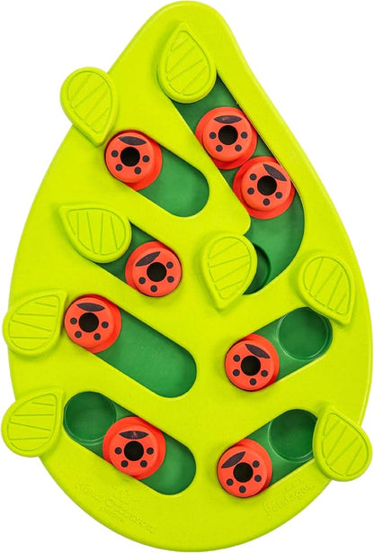 Close-up of green leaf-shaped cat puzzle feeder with red ladybug pegs