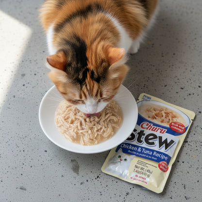 Cat eating shredded chicken and tuna Churu Stew from a bowl