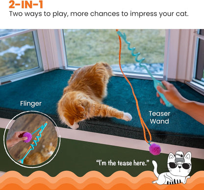 Cat playing with a Flinger and Teaser Wand toy on a windowsill.