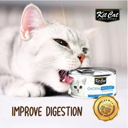 Cat enjoying Kit Cat Chicken Mousse with Tuna Topper wet cat food.