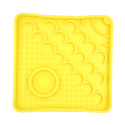 Yellow LickiMat Catster slow feeder for cats with textured enrichment feeding surface and hydration well.