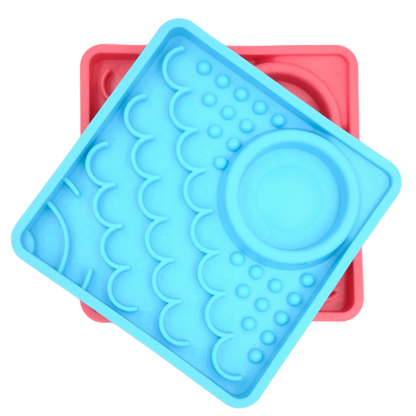 Blue and pink LickiMat Kitty slow feeder mats for kittens shown together.