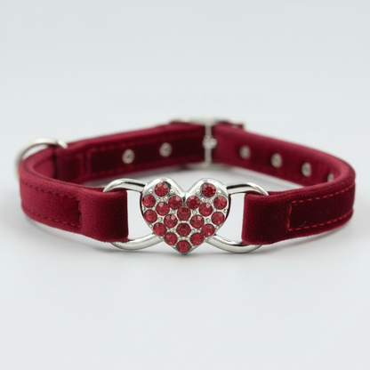 Red cat collar with a heart-shaped rhinestone buckle on a white background