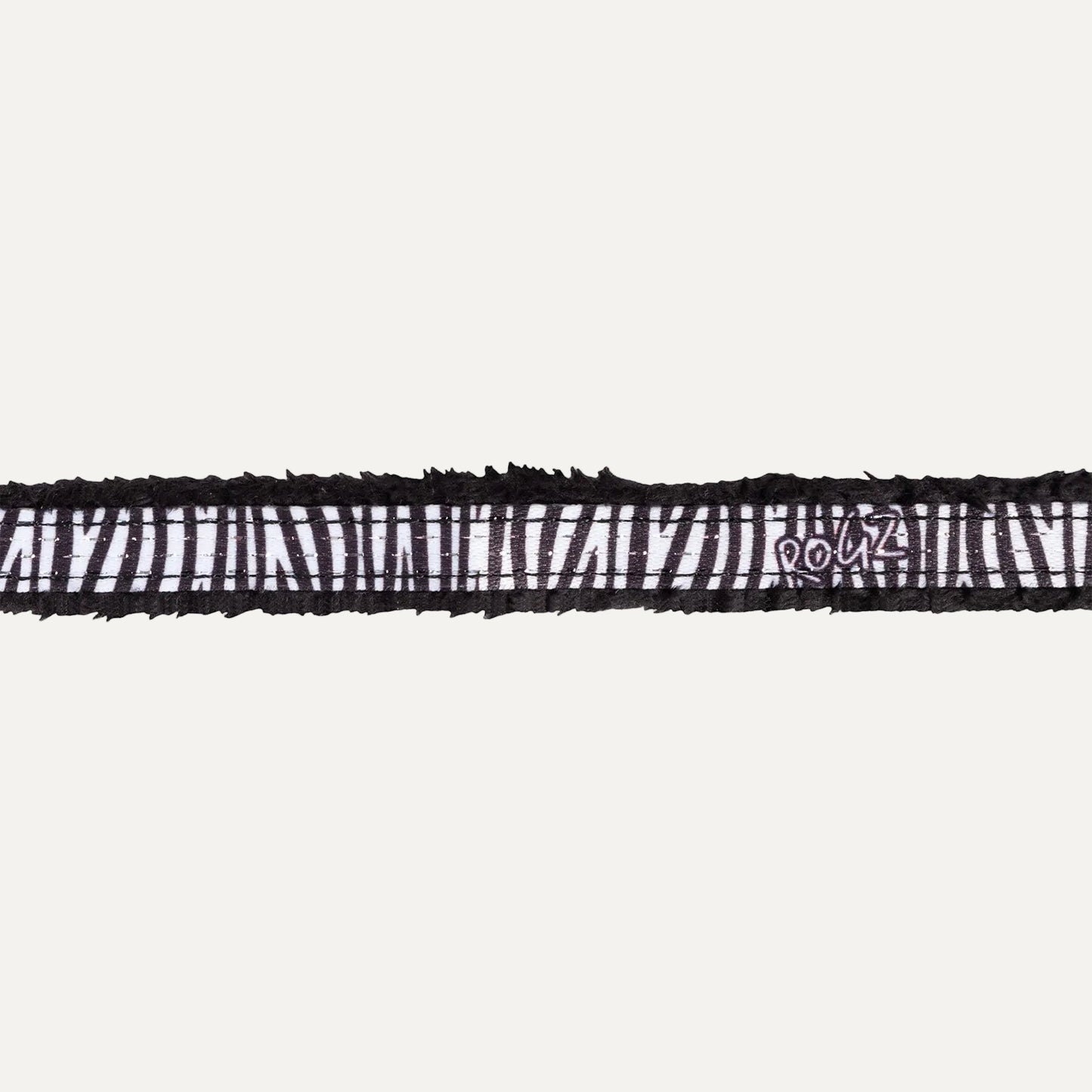 Close-up of Rogz FashionCat Safety Collar in Zebra print with black and white safari-inspired pattern