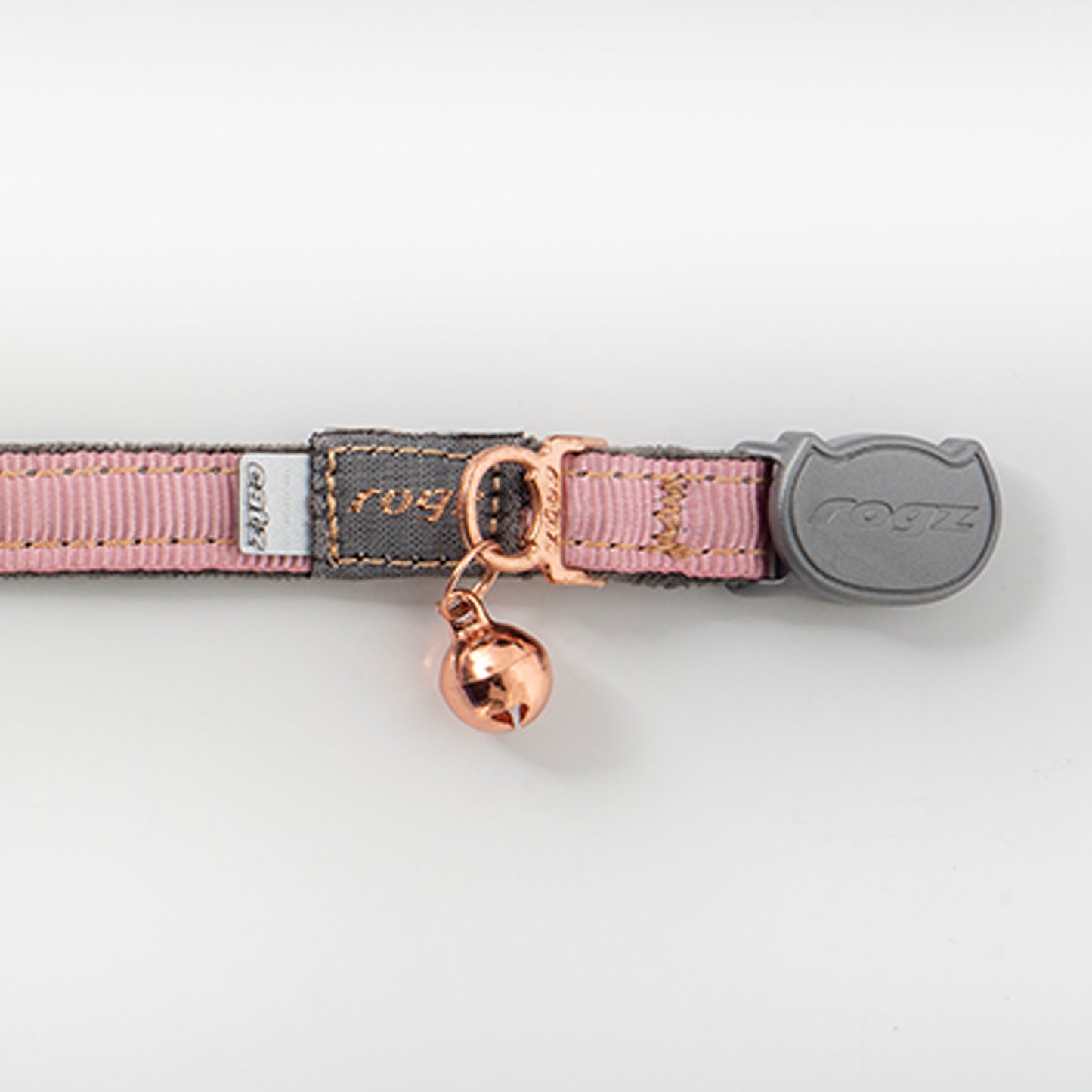 Close-up of Rogz UrbanCat Safety Collar in Pink Blush with rose gold bell, soft plush webbing and breakaway safety buckle
