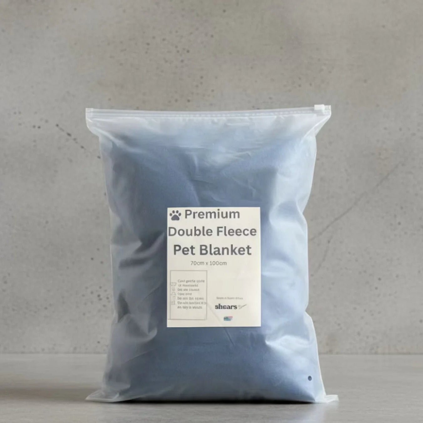 Packaged Shears navy ultra-soft cat comfort fleece blanket in a reusable zip bag, ideal for kneading, comfort suckling and cosy naps.