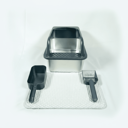 Cat litter box set with scoop, brush, and mat on a white background